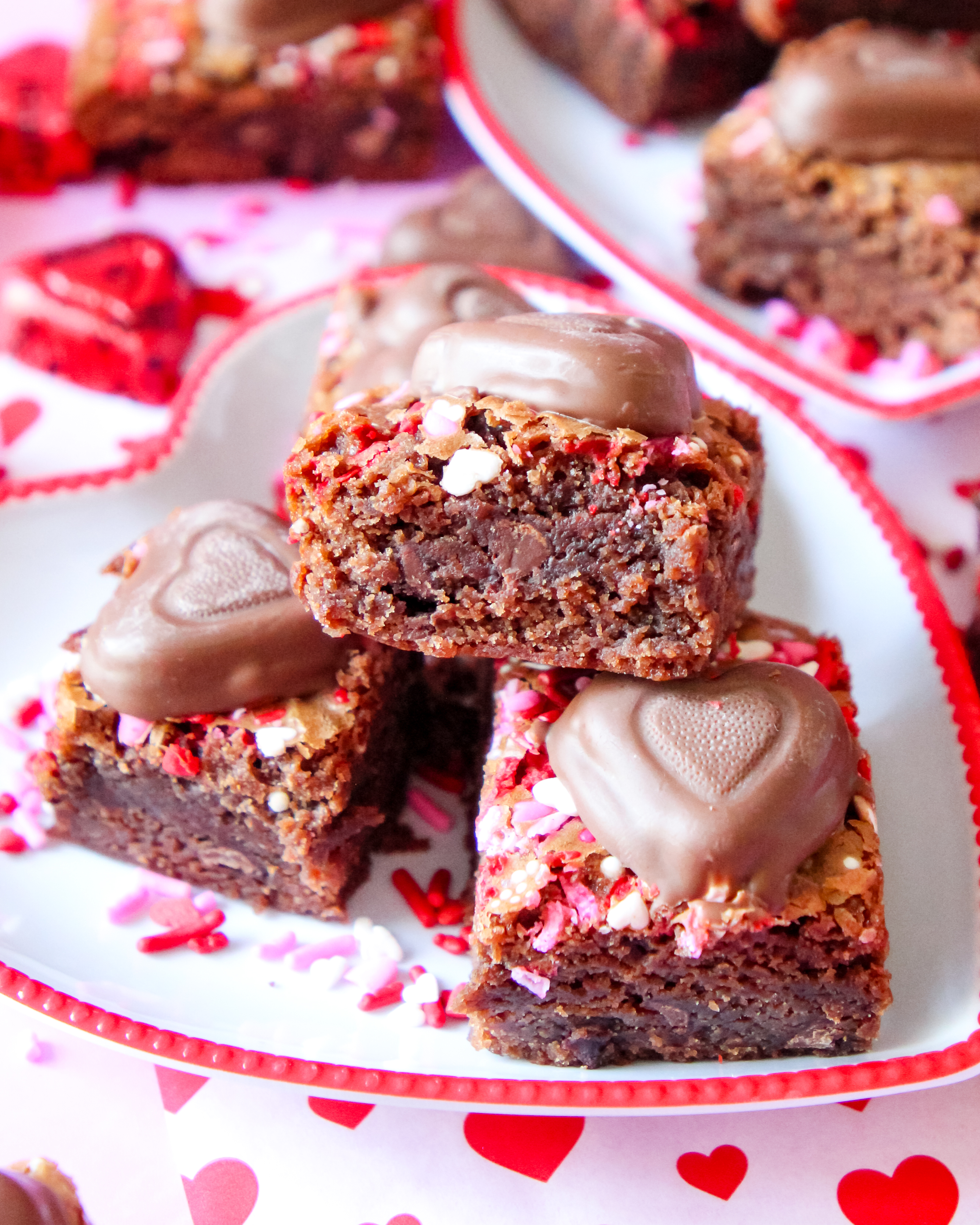 A stack of fudgy Berry Much in Love Brownies with a glossy berry swirl, rich chocolate layers, and a decadent, moist texture.