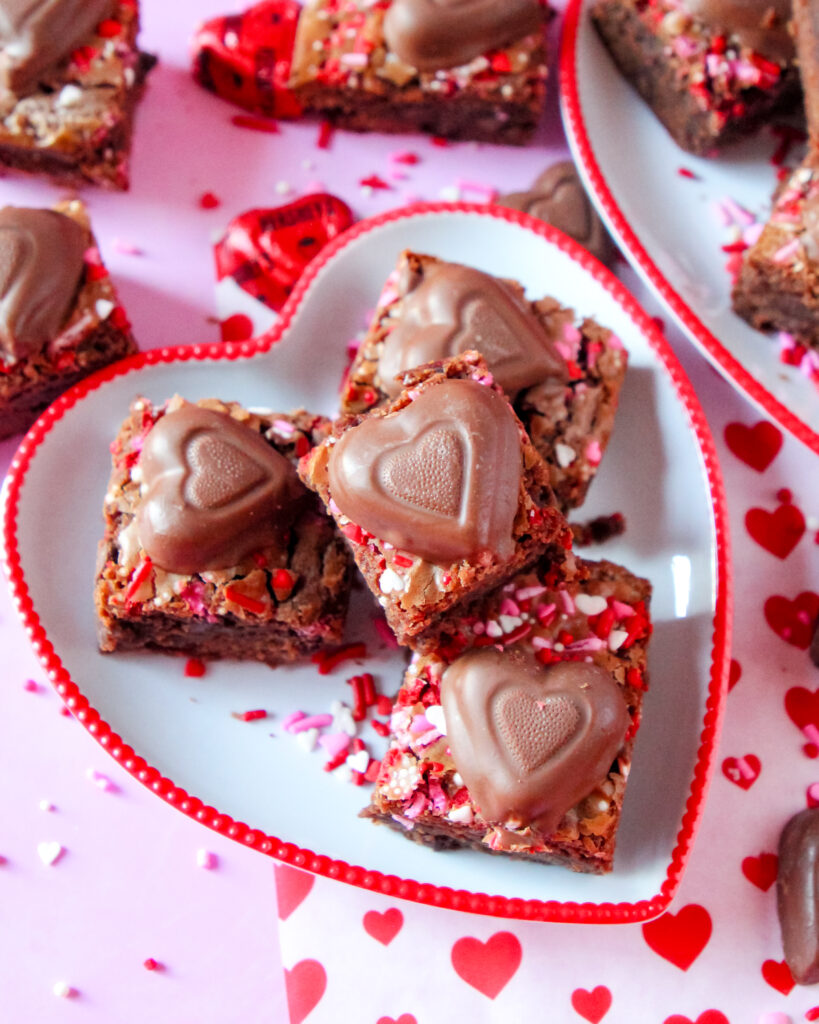 A stack of fudgy Berry Much in Love Brownies with a glossy berry swirl, rich chocolate layers, and a decadent, moist texture.