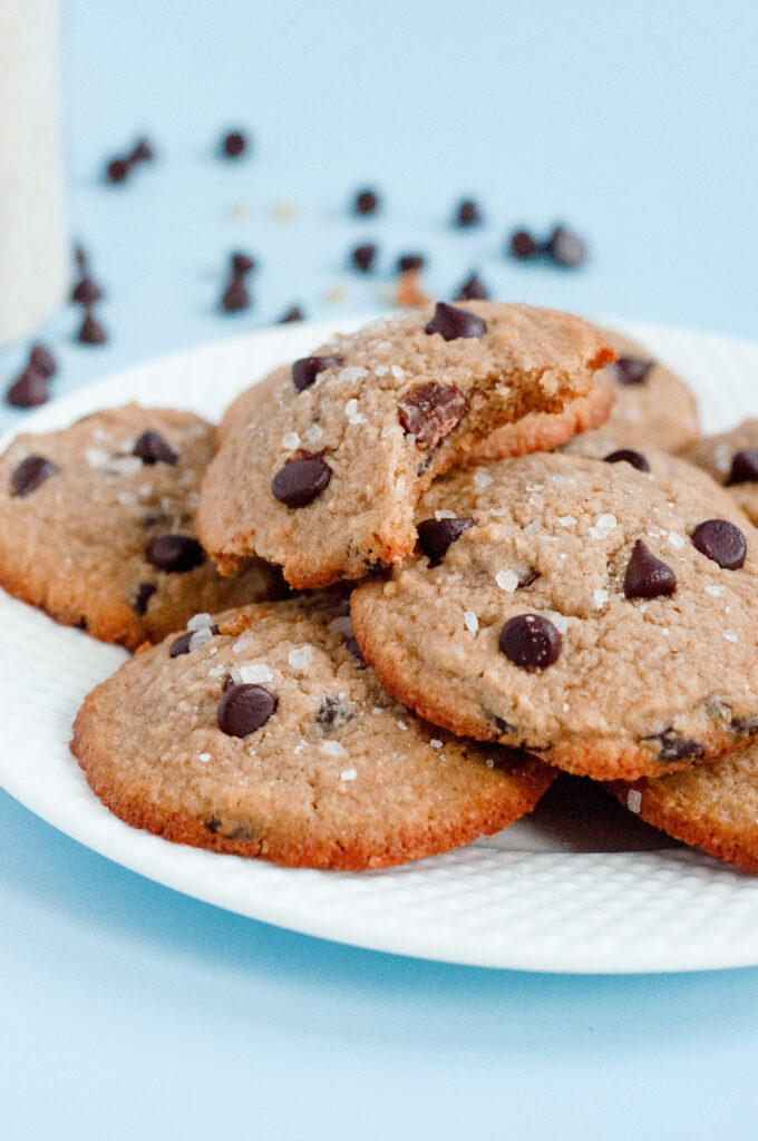 A stack of Low-Sugar Brown Butter Chocolate Chip Cookies with golden edges, melty chocolate chips, and a rich, nutty aroma.