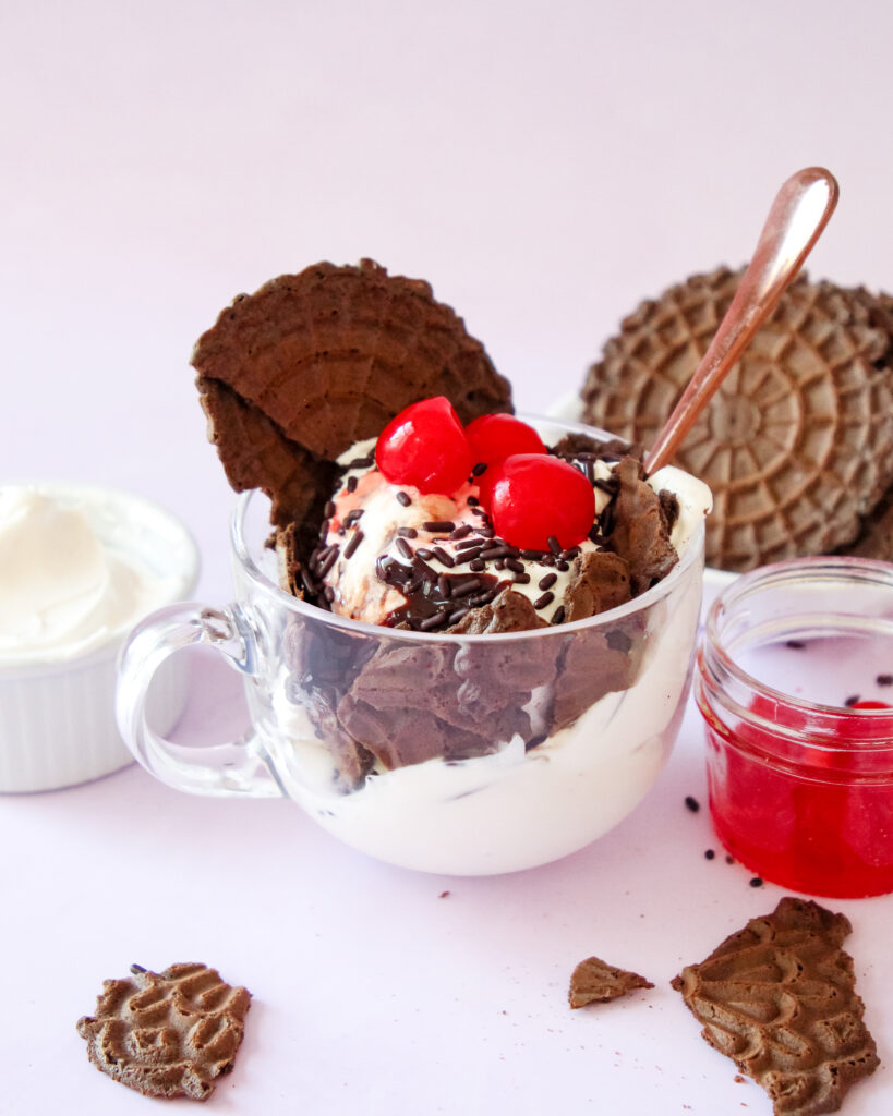 Pizelle ice cream sundae topped with chocolate sauce and sprinkles.