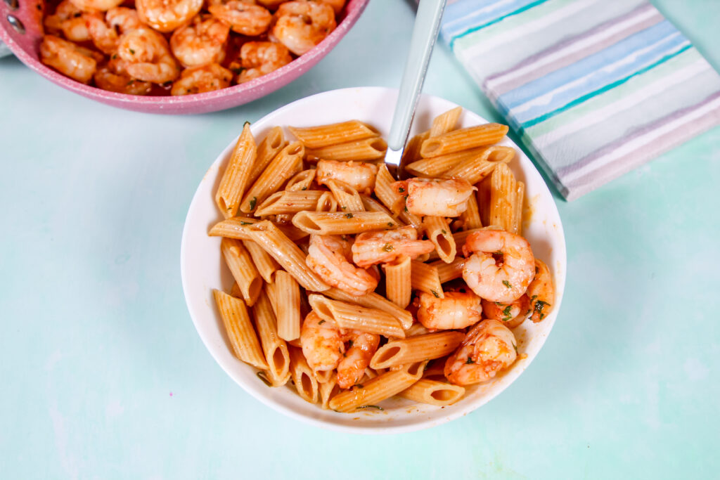 Garlic shrimp cooked in butter and topped with Hawaiian red sea salt, served in a skillet with fresh parsley.