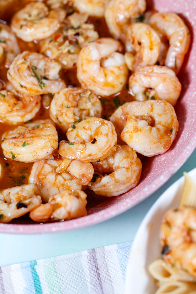 Garlic shrimp cooked in butter and topped with Hawaiian red sea salt, served in a skillet with fresh parsley.