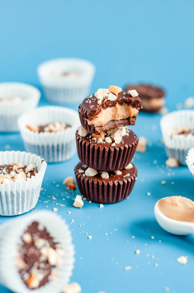 Rich dark chocolate nut cups topped with crushed almonds for a healthy, homemade treat.