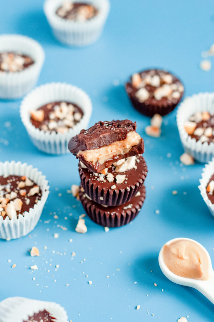 Cashew butter filling being added to homemade low-sugar chocolate cups.