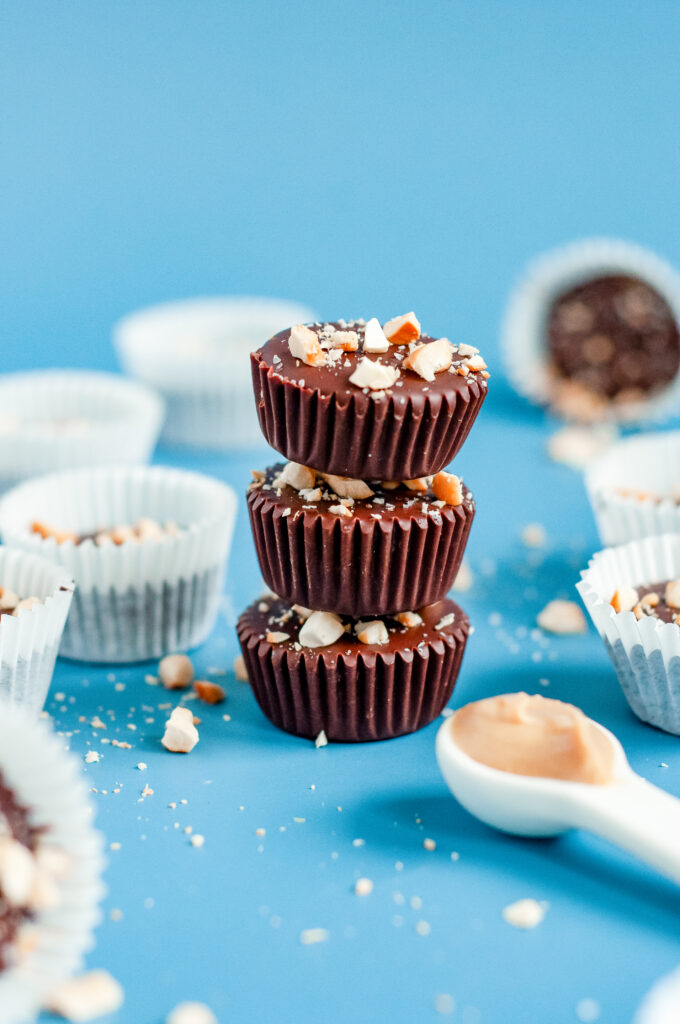 Rich dark chocolate nut cups topped with crushed almonds for a healthy, homemade treat.