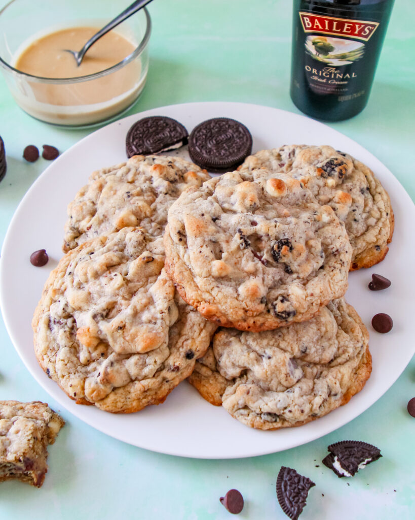 A close-up of thick, jumbo Baileys Irish Cream cookies with melty chocolate, toffee, and crushed chocolate sandwich cookies.