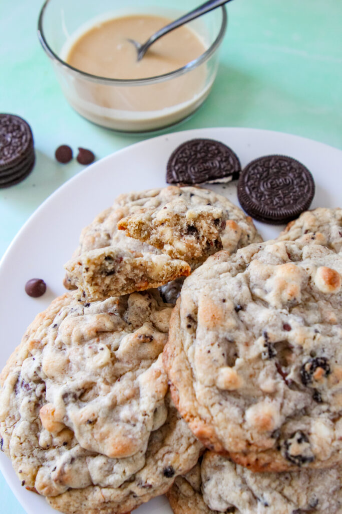 A close-up of thick, jumbo Baileys Irish Cream cookies with melty chocolate, toffee, and crushed chocolate sandwich cookies.