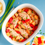 Colorful Hawaiian chicken cooked in a sticky pineapple-chili sauce with bell peppers and pineapple chunks served over white rice.