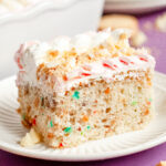 A pink and white frosted sheet cake with crushed golden Oreos, piped buttercream, and soft pastel sprinkles, perfect for Mother’s Day.