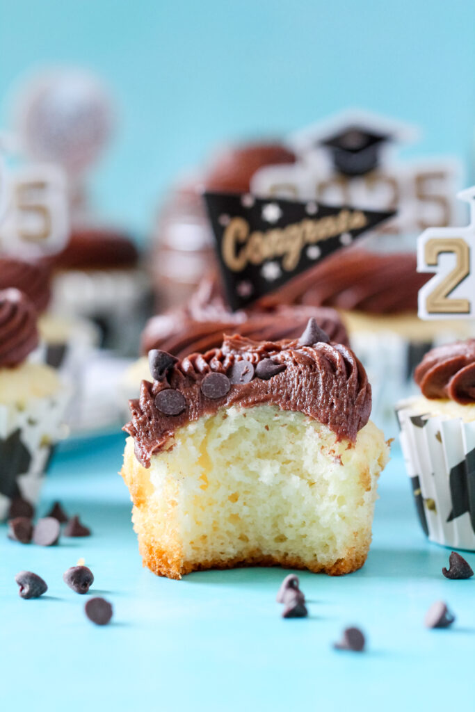 Chocolate almond cupcakes topped with swirled Nutella frosting and mini chocolate chips, perfect for graduation celebrations.