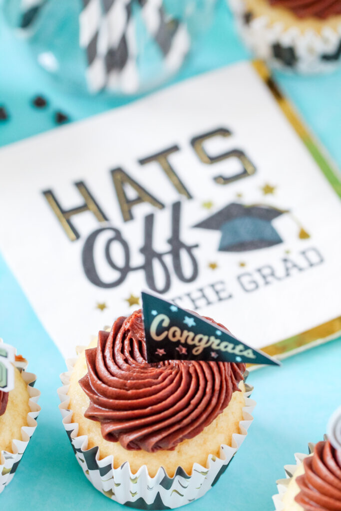 Chocolate almond cupcakes topped with swirled Nutella frosting and mini chocolate chips, perfect for graduation celebrations.
