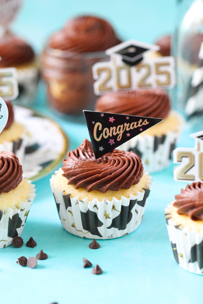 Chocolate almond cupcakes topped with swirled Nutella frosting and mini chocolate chips, perfect for graduation celebrations.