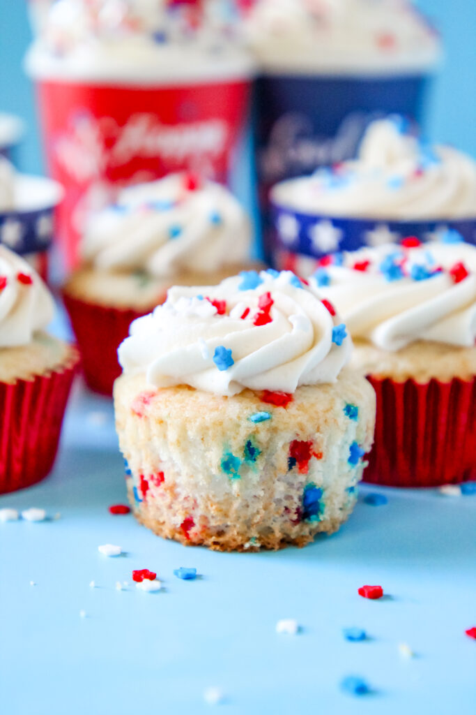 Patriotic Cupcake perfect for Fourth of July with patriotic sprinkles on top of the frosting in a festive patriotic cupcake liner.