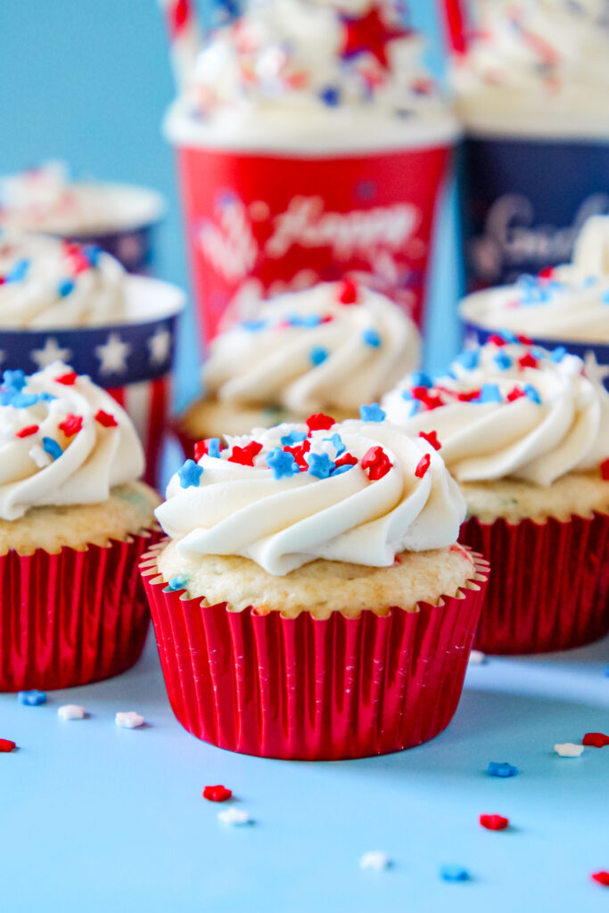 Patriotic Cupcakes perfect for Fourth of July with patriotic sprinkles on top of the frosting in a festive patriotic cupcake liners.