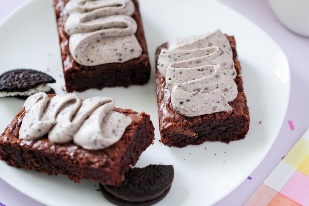 Several of the Toblerone Crunch Brownie Bars with Whipped Oreo Frosting on a plate.