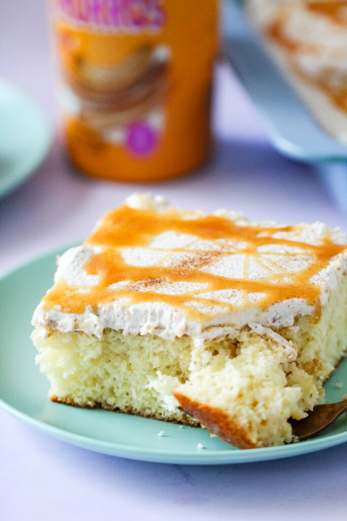 A slice of Churro Cream Poke Cake.