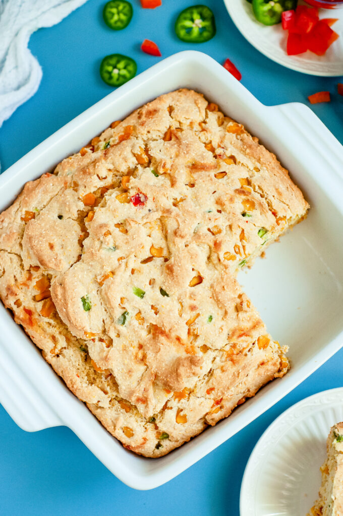 A loaf of loaded cornbread with cheese, cornbread, and green onions using Dolly Parton's Cornbread Mix.