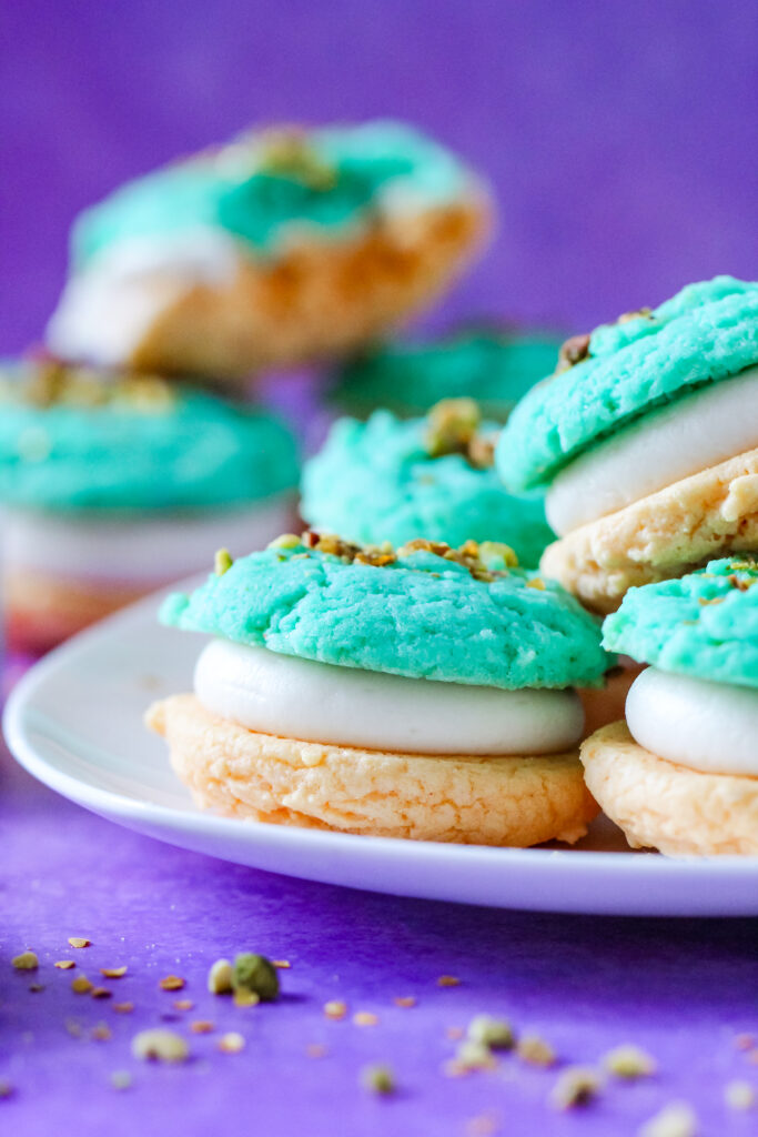 A plate of Pistachio and Orange Blossom Cookie Sandwiches Inspired by Jasmine from Aladdin.