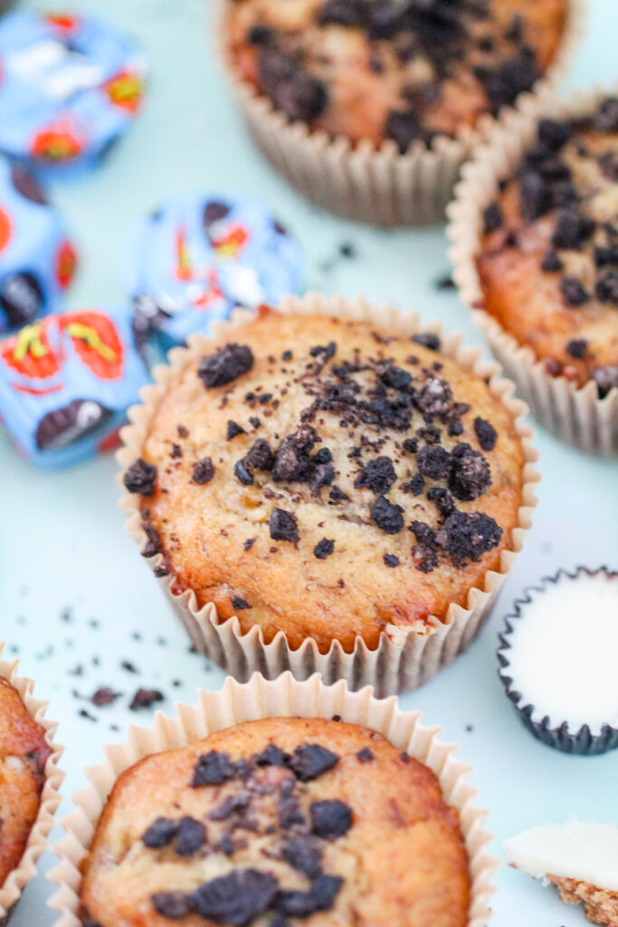 Banana Butter Cup Crunch Muffins: moist banana muffins studded with peanut butter cup chunks and Oreo crumbs