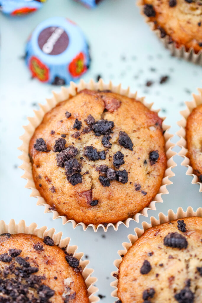 Close up of Banana Butter Cup Crunch Muffins: moist banana muffins studded with peanut butter cup chunks and Oreo crumbs