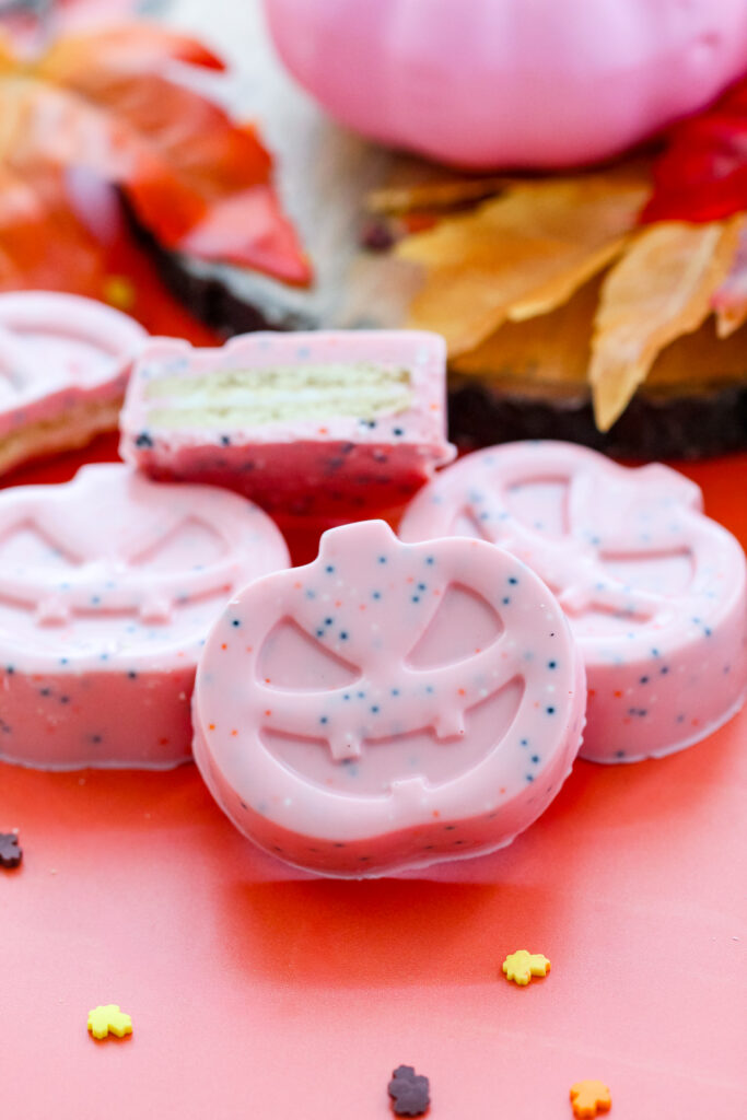 Image of a Sprinkled Pink Pumpkin Covered Cookies perfect for Halloween.
