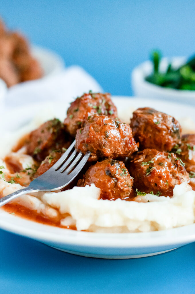 Sweet cider BBQ meatballs recipe served over buttery mashed potatoes — easy fall comfort food with apple cider BBQ glaze.