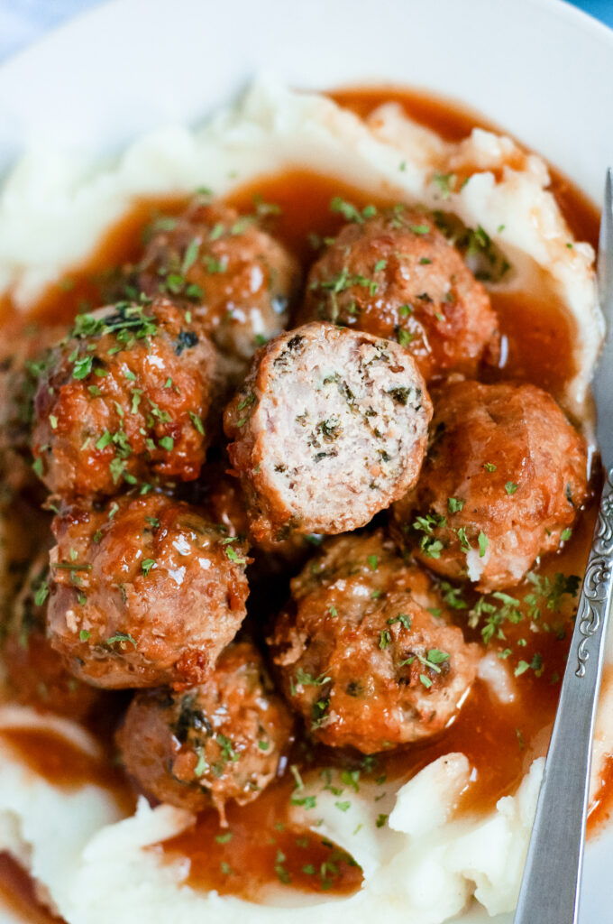 Sweet cider BBQ meatballs recipe served over buttery mashed potatoes — easy fall comfort food with apple cider BBQ glaze.