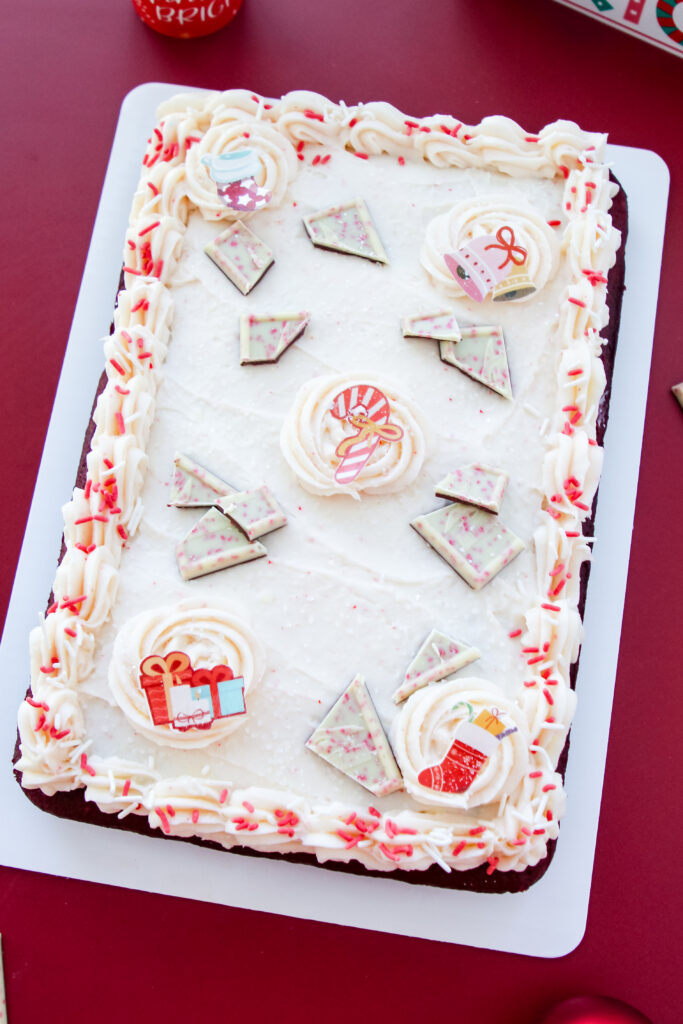 Red Velvet Candy Cane Cake with white buttercream, peppermint sprinkles, and candy toppings — an easy festive dessert for Christmas.