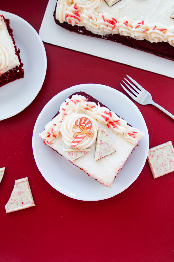 Red Velvet Candy Cane Cake with white buttercream, peppermint sprinkles, and candy toppings — an easy festive dessert for Christmas.