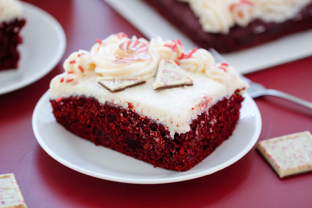 Red Velvet Candy Cane Cake with white buttercream, peppermint sprinkles, and candy toppings — an easy festive dessert for Christmas.