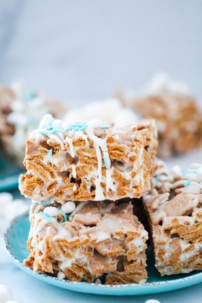 An image of Snow Days Golden Grahams Bars — chewy marshmallow cereal treats made with Golden Grahams, white chocolate, and festive winter sprinkles.